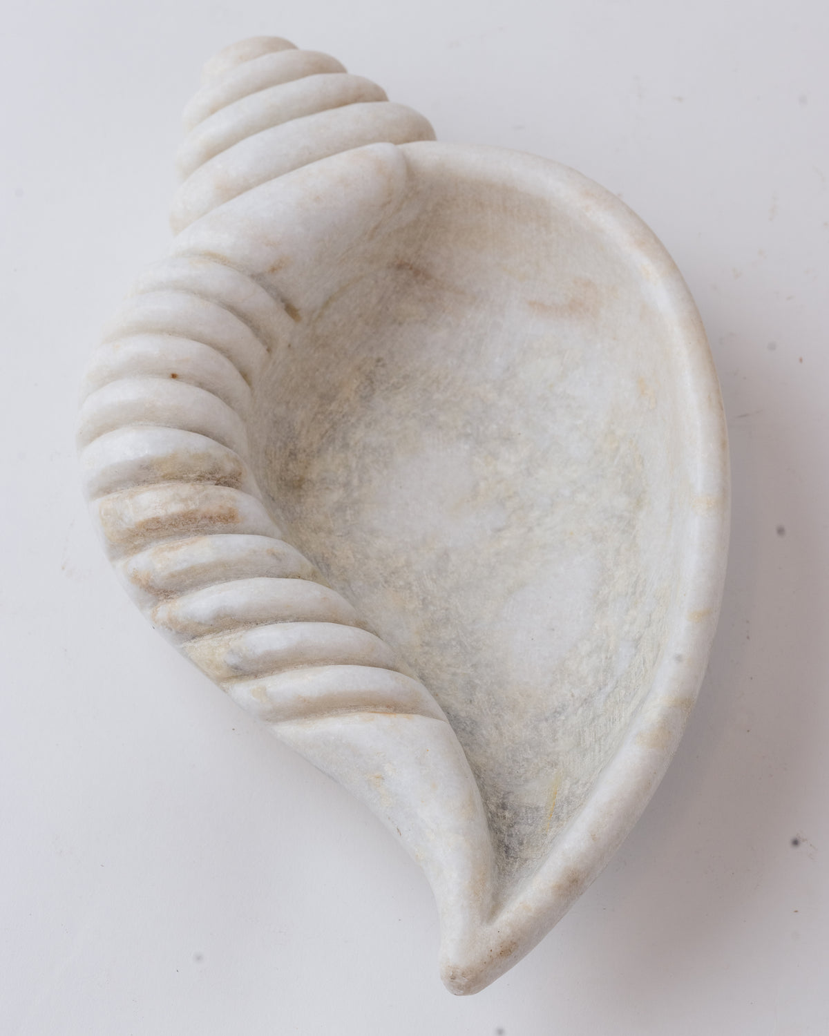 Hand-carved marble urli in a conch form